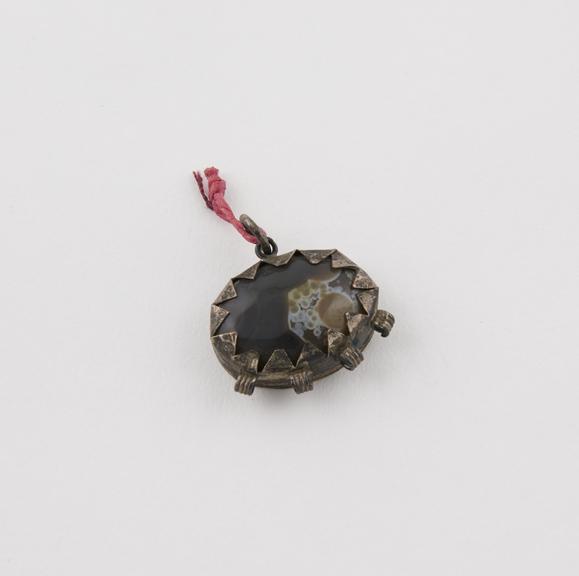 Amuletic pendant, brownish agate set in oval silver mount