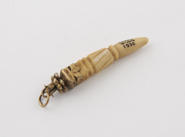 Horn-shaped bone pendant with decorated brass mount