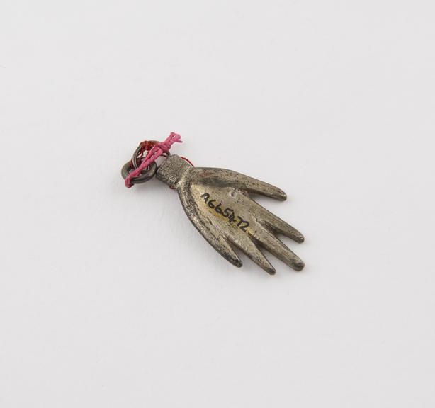 Small silver ex-voto hand, fingers and thumb outstretched