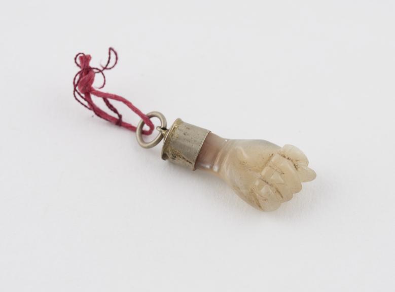 Amulet, carved mother-of-pearl fist