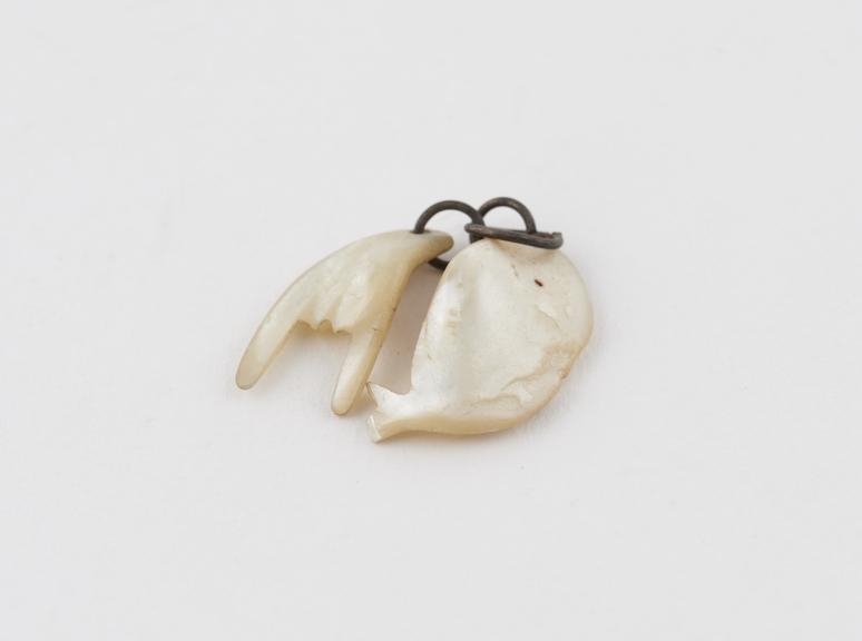 Amuletic pendant consisting of mother-of-pearl fish and hand in