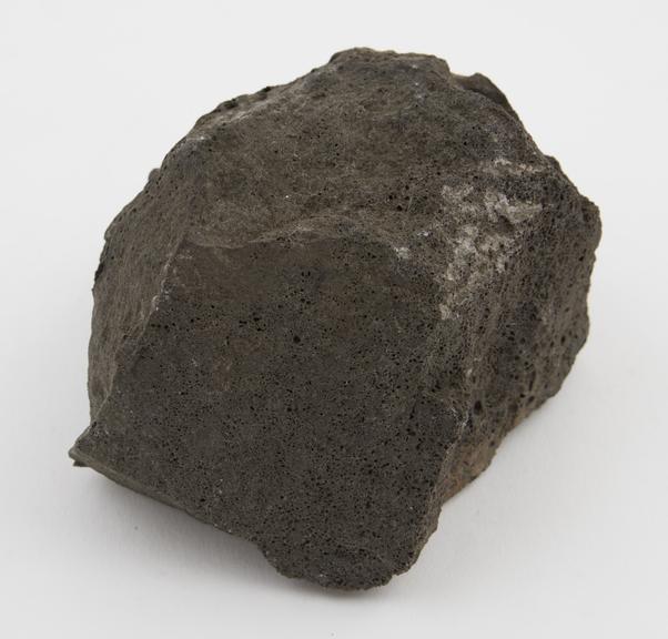 Scoriaceous, semi-crystalline, dark-grey slag