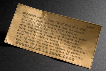 Label describing coin removed from child