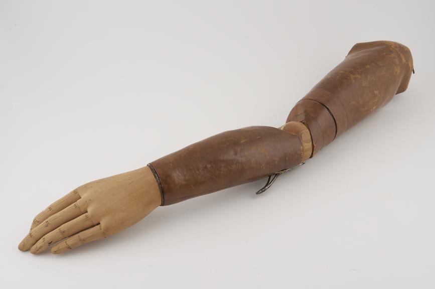 Left above elbow prosthesis with a leather socket and wooden