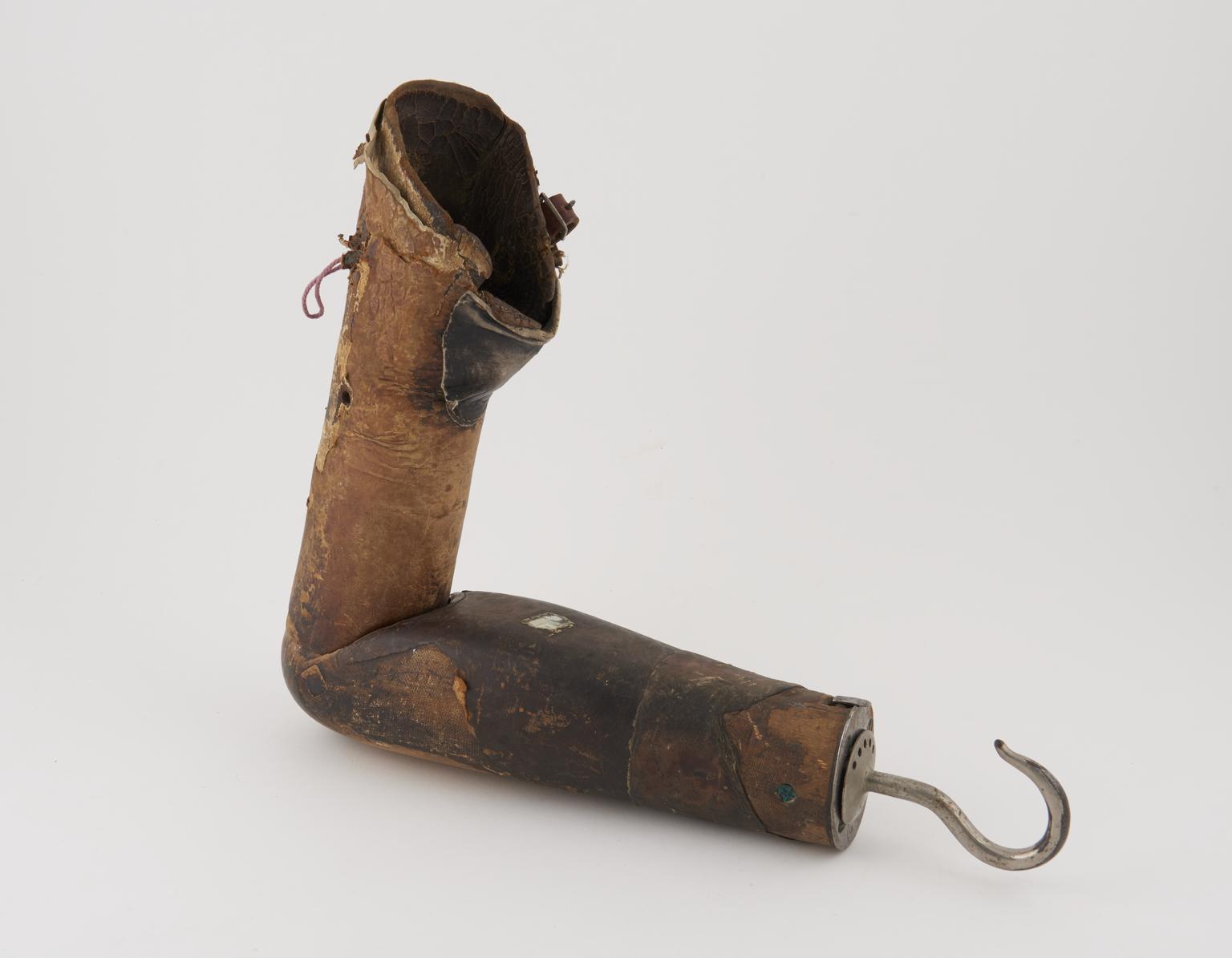 Old and well-worn above elbow prosthesis with a leather socket ...