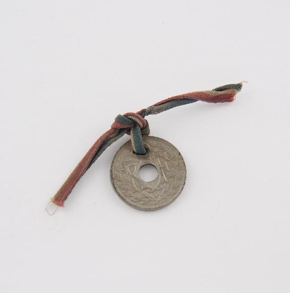 Amulet, metal, coin, value of 5 centimes, with tricolour ribbon