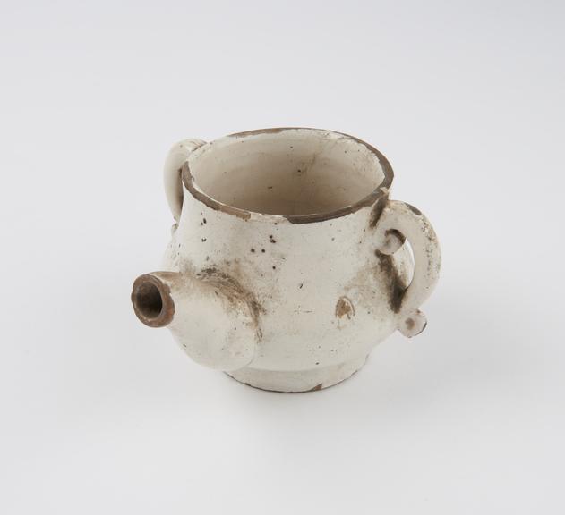 Invalid feeding cup in off-white tin glazed earthenware