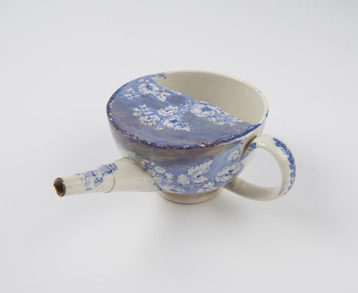 Blue and white transfer pattern feeding cup, broken, Crellin 52