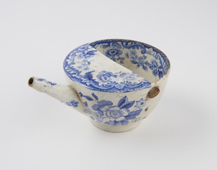 Blue and white transfer pattern feeding cup, handle missing