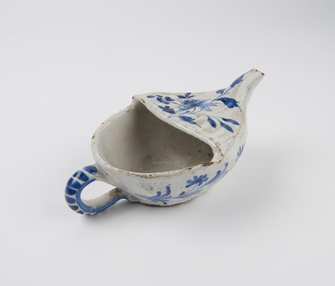 Tin glazed earthenware pap boat with blue painted decoration