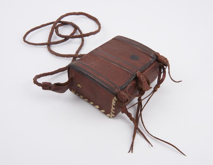 Leather covered amulet case with cloth lining flap at front