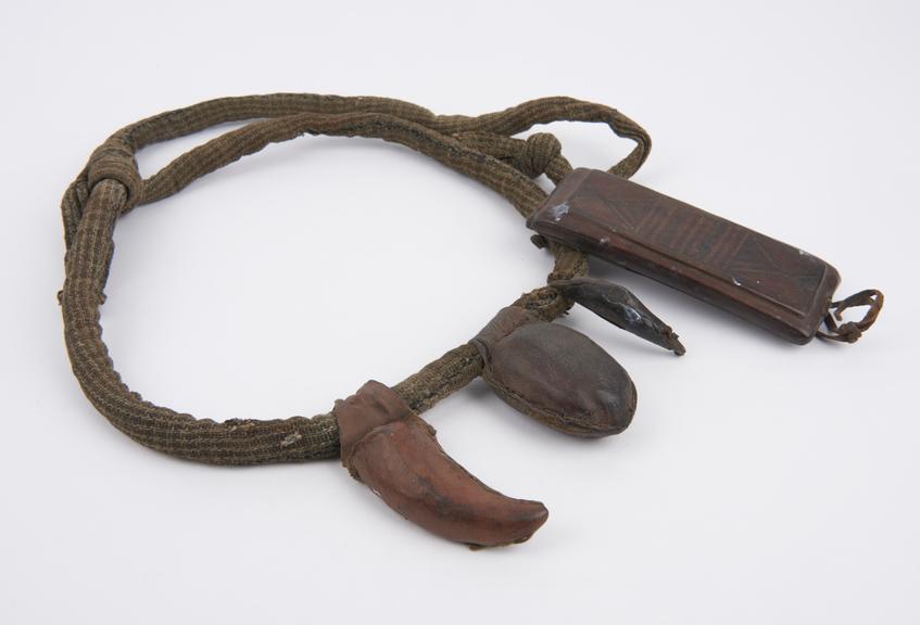 Girdle, amuletic, cotton rolled to make a circular padded tube