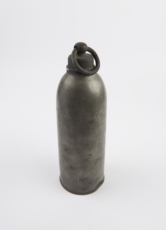 Cylindrical pewter hot water bottle with brass screw top with