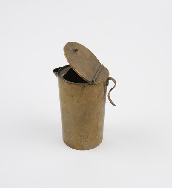 Cylindrical brass container with spout