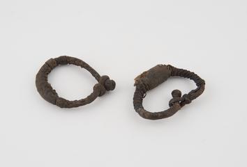 Two leather bracelets containing amulets in bulbous dilations