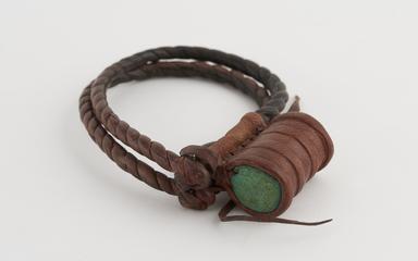 Double leather plaited bracelet with drum shaped amulet attached