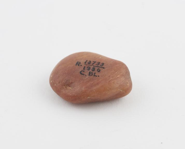 Deep pink tongue-shaped pebble for woman who is dumb