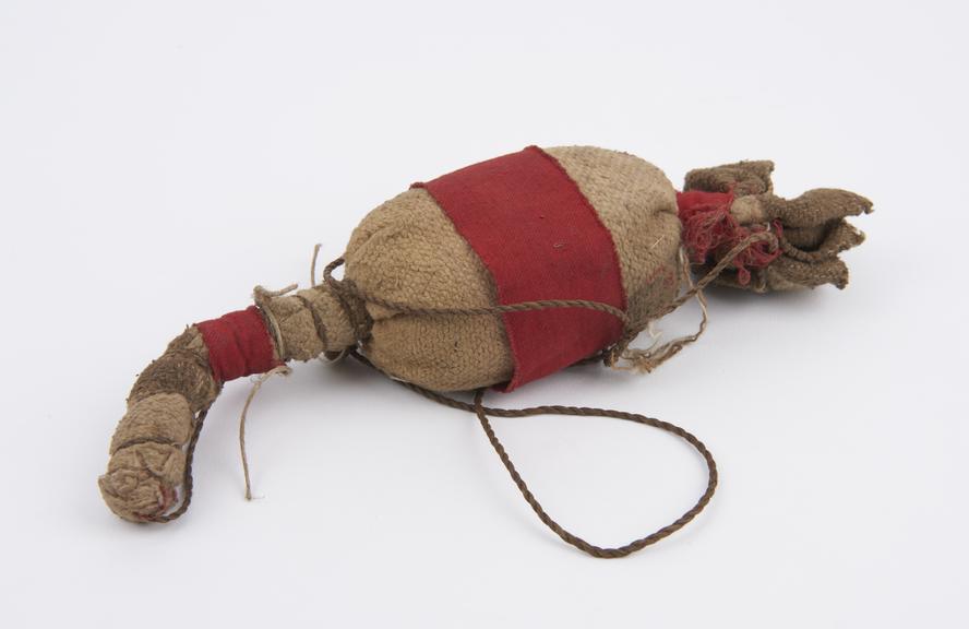 Medicine man's bag made of cloth with bound ends and fibre sling