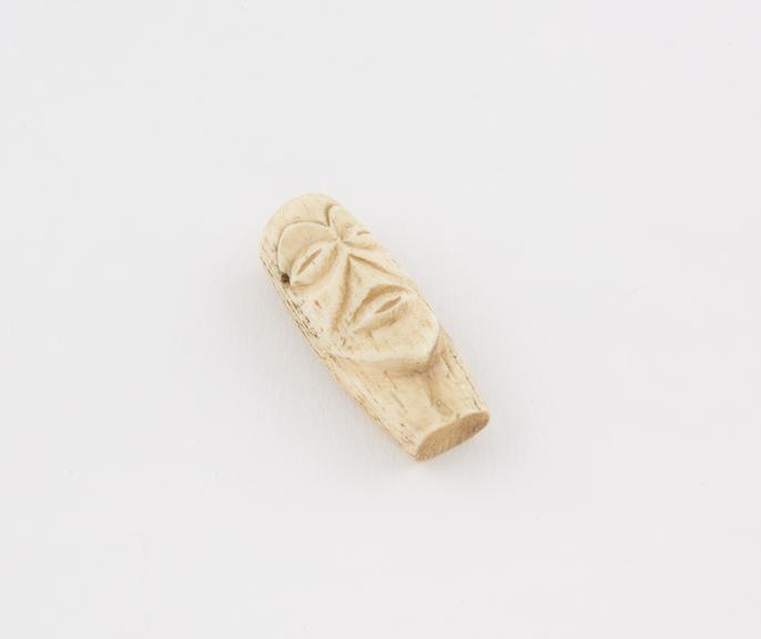 Ivory amulet in the form of a carved face from Kasai, Zaire