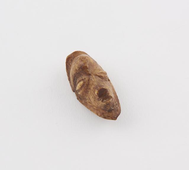 Ivory amulet in the form of a carved face, from Zaire