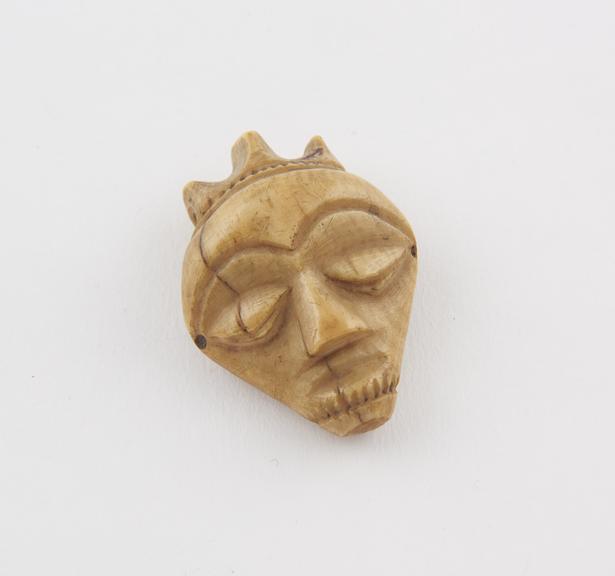 Ivory amulet, in the form of a face, made by the Bapende tribe