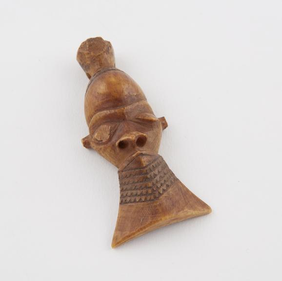 Ivory amulet, in the form of a face, by the Bapende tribe, Zaire