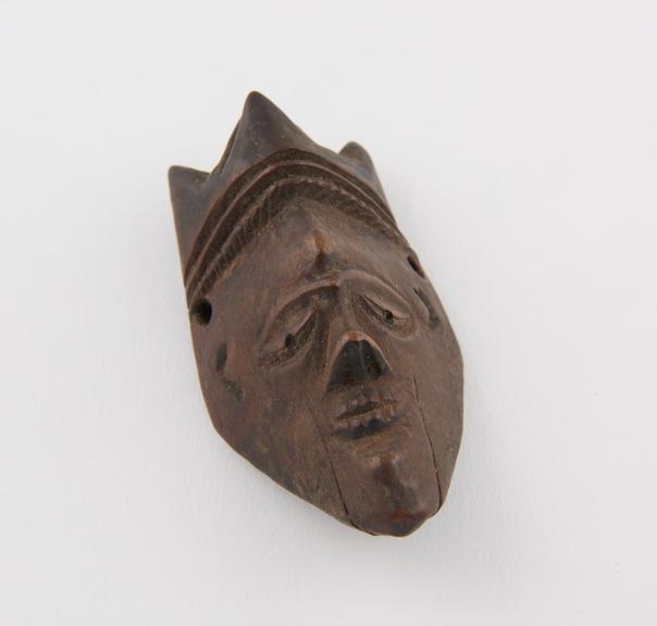 Wooden amulet, in the form of a face, by the Bapende tribe