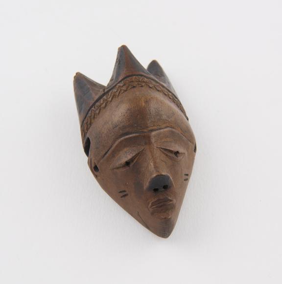 Wooden amulet, in the form of a face, by the Bapende tribe