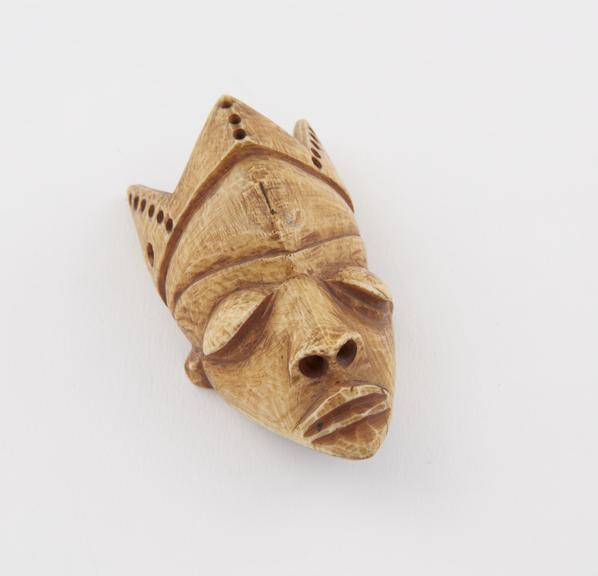 Ivory amulet, in the form of a face, by the Bapende tribe, Zaire