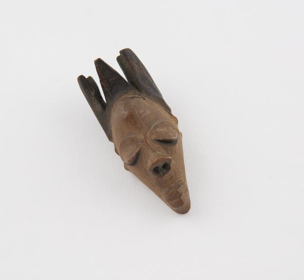 Wooden amulet, in the form of a head, made by Bapende tribe