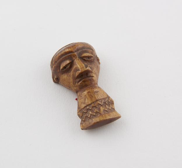 Ivory amulet in the form of a carved face