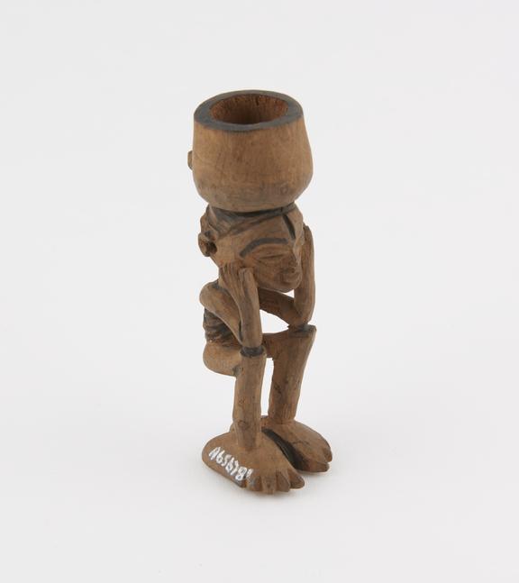 Carved wooden snuff mortar in the form of a squatting human