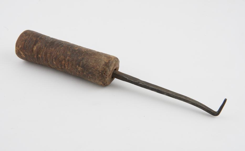 Cautery consisting of flat hooked metal blade with wooden
