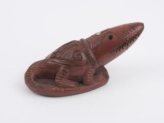 Red earthenware foot-scraper in the form of a crocodile