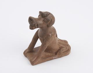 Light brown earthenware foot-scraper in the form of a dog