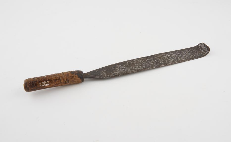 Long steel blade with serrated edges and curved tip