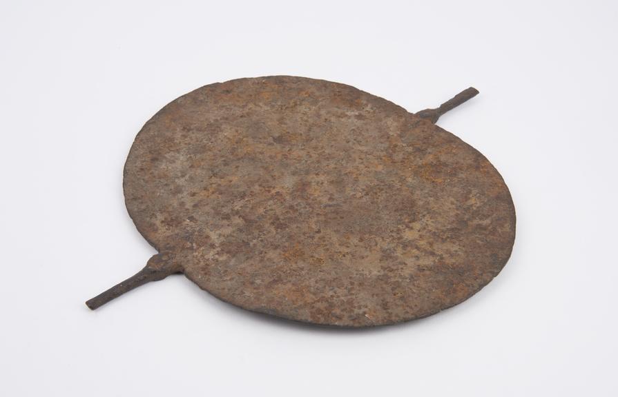 Iron spade', elongated disc with two projecting handles