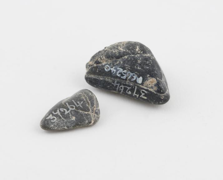 Two grey pieces of stone, flint-like