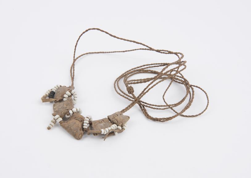 Amuletic necklace consisting of small buff-coloured leather