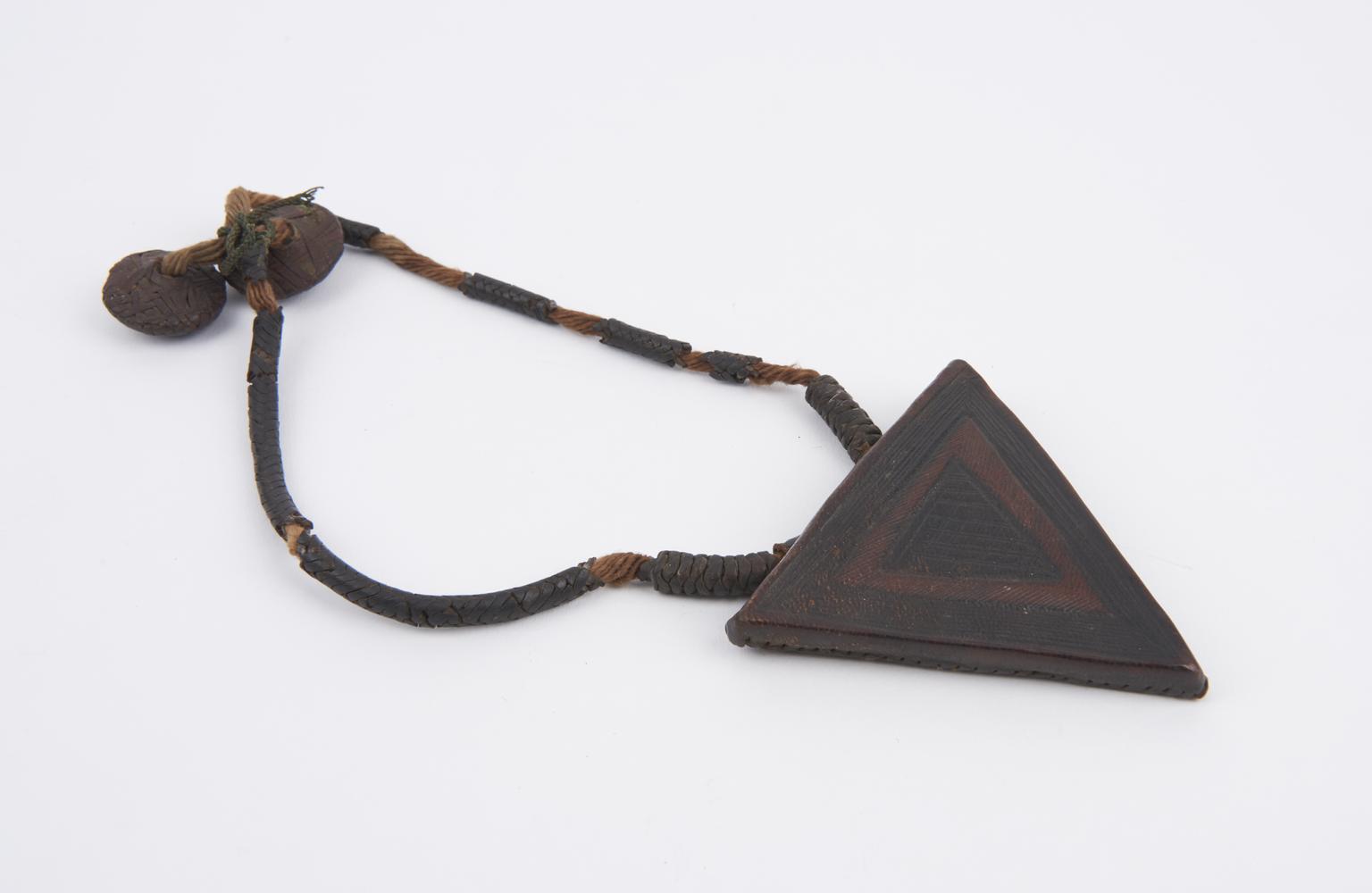 Triangular leather amulet suspended from cord of fibre and plaited ...