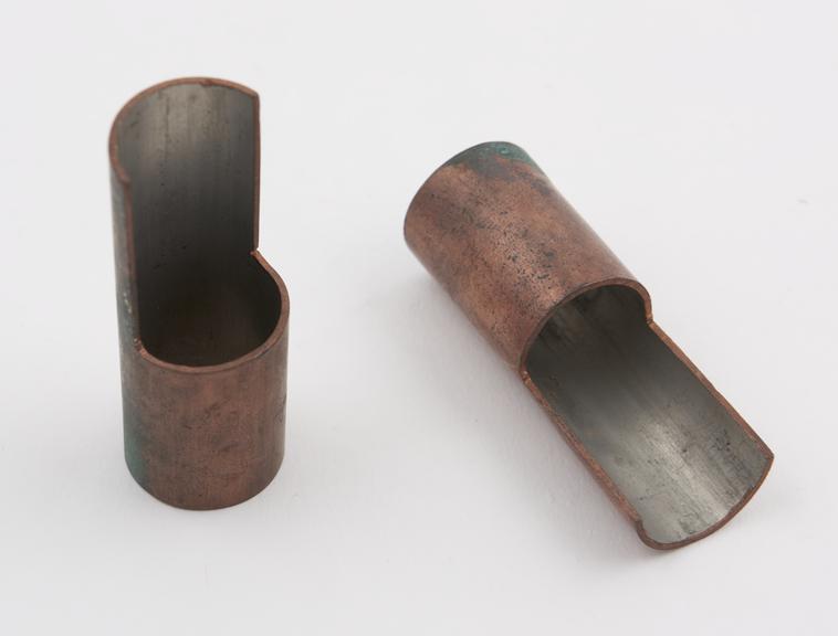 Two copper tubes, partially sectioned