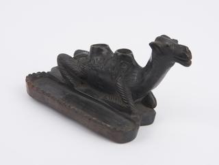 Black earthenware foot-scraper in the form of a camel