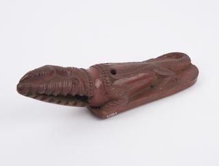 Red earthenware skin scraper