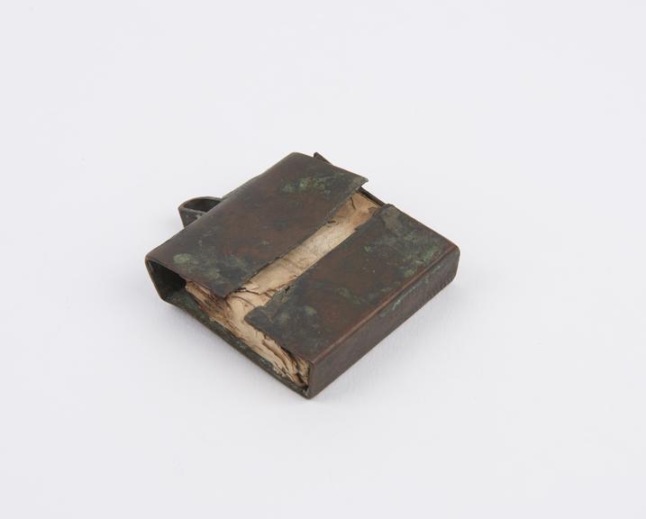 Amulet  case of copper containing papers