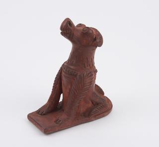 Brown earthenware foot scraper in the form of a seated dog