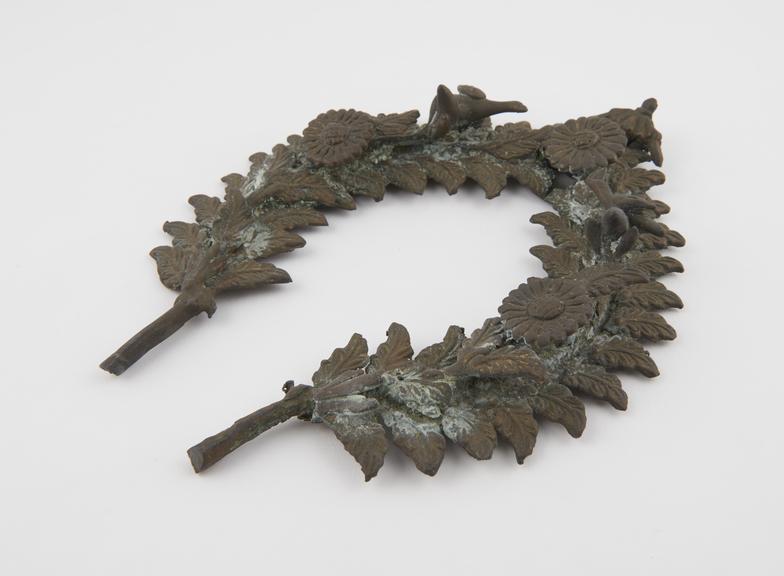 Piece of cast ornamental metalwork wreath of leaves with three