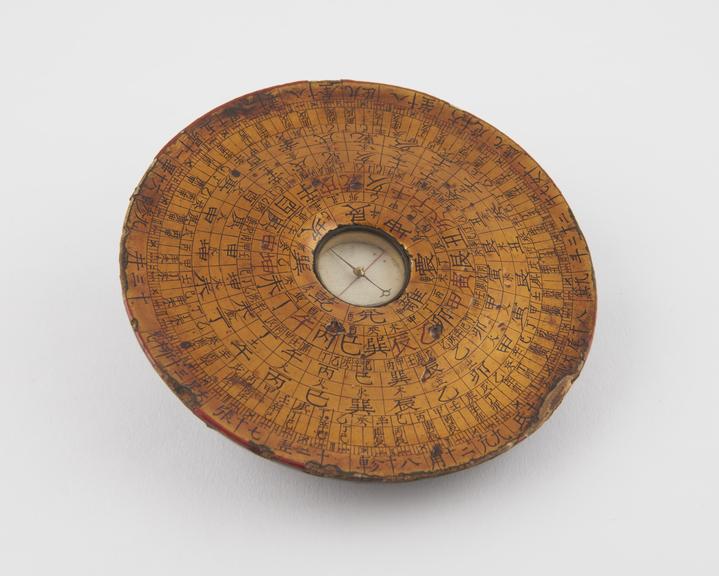 Circular wooden compass, inscribed with Chinese characters