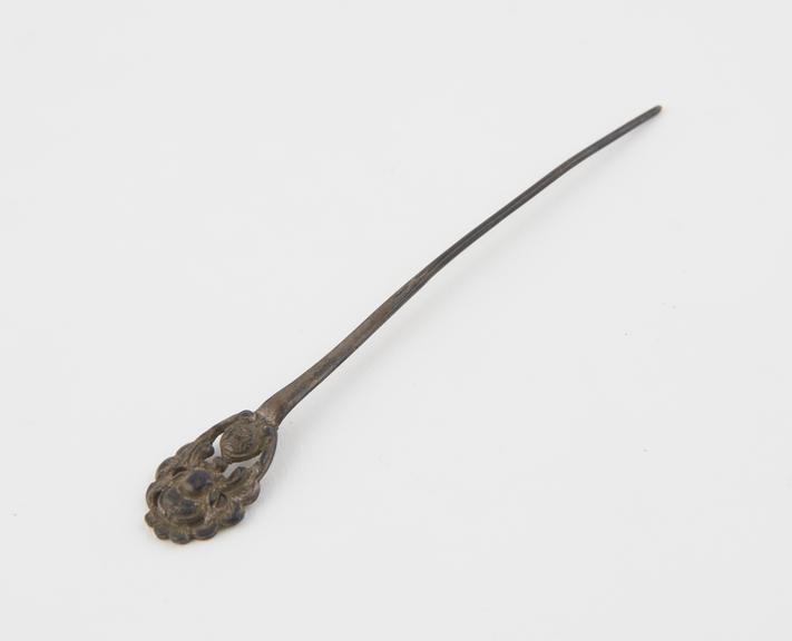 Metal hair pin, finial has embossed lotus blossom and leaves