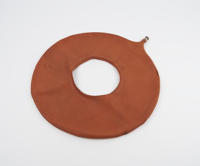 Round doughnut-shaped air-filled pressure cushion