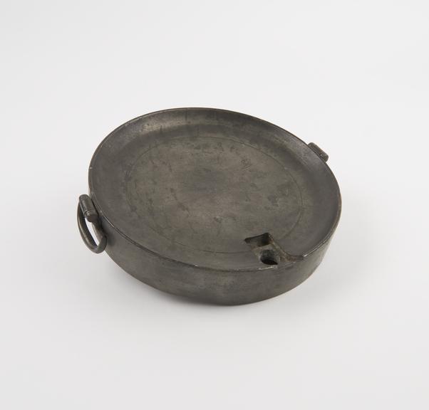 Flat circular pewter hot water bottle, stopper fitting missing
